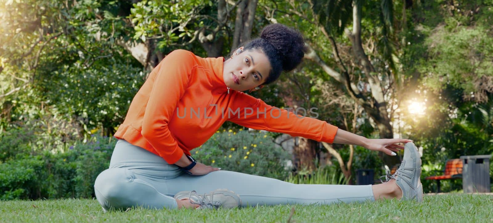 Stretching, calm and breathing woman on grass in park or nature environment for fitness workout session. Wellness and health lifestyle of sports person doing muscle relax exercise sitting on ground.