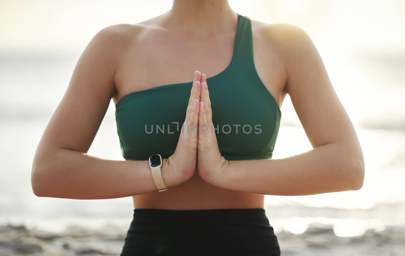 Woman, hands and yoga in meditation on the beach for spiritual wellness, zen or workout in the outdoors. Hand of female yogi meditating or namaste for calm, peaceful mind or awareness by the ocean by YuriArcurs