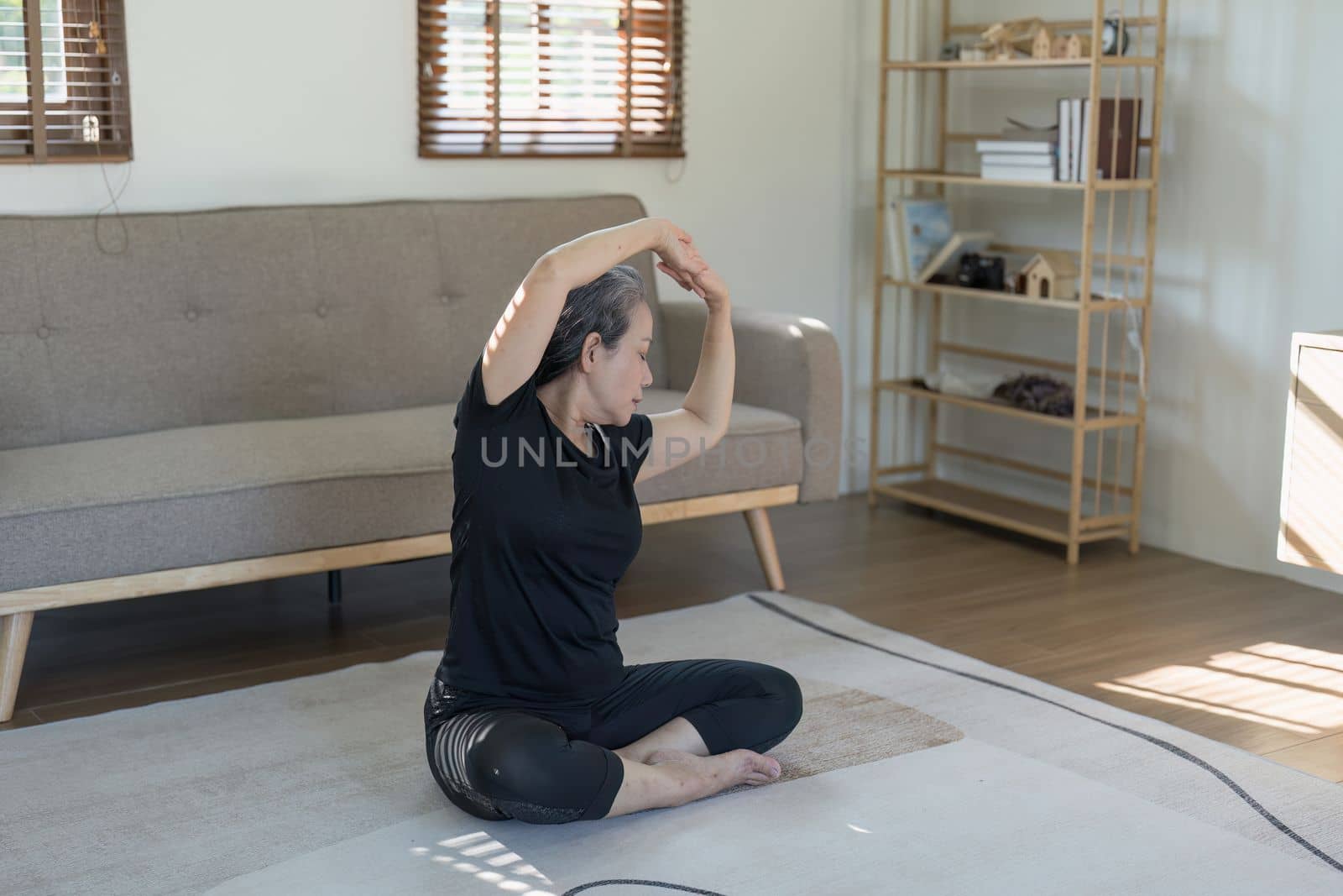 Portrait of Mature Woman doing stretching yoga side bend. exercise and stretching concept.