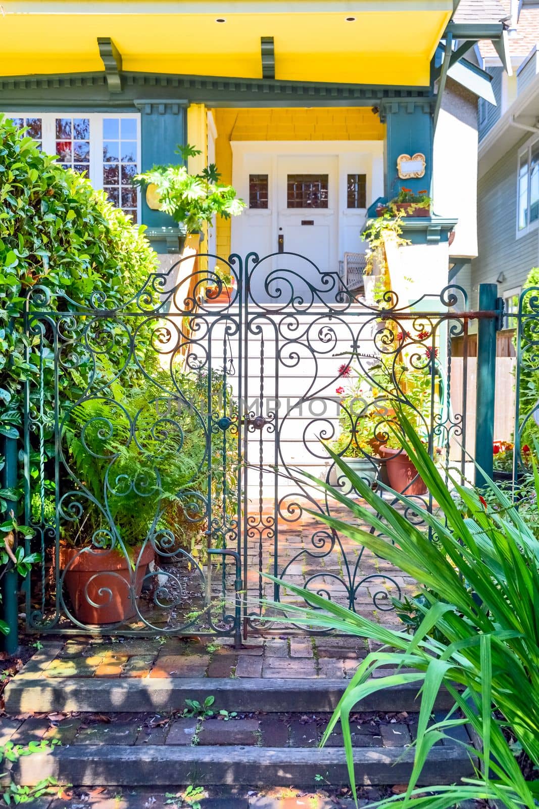 Decorated gate in front of residential house entrance.