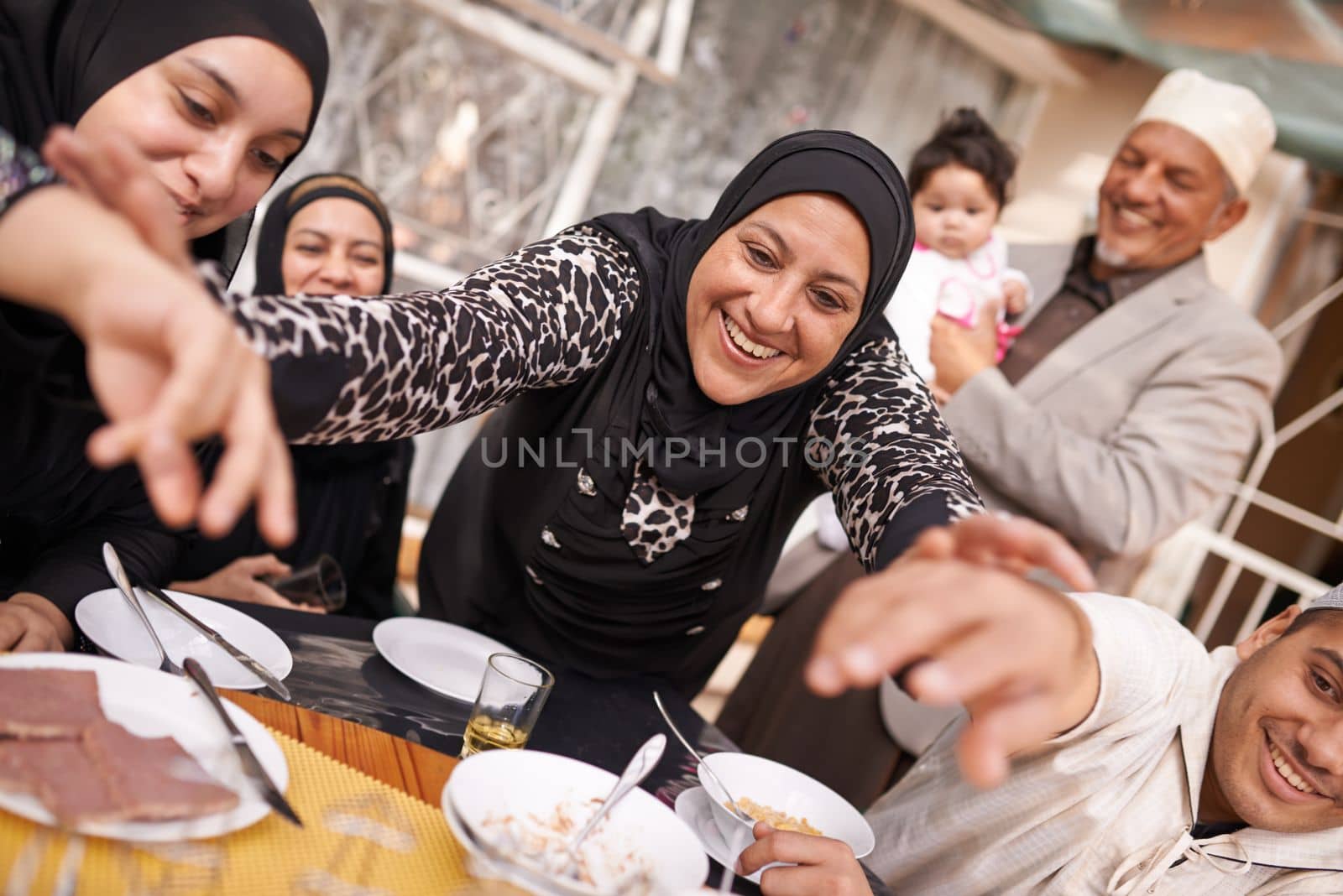 Theres enough for everyone. a muslim family eating together. by YuriArcurs