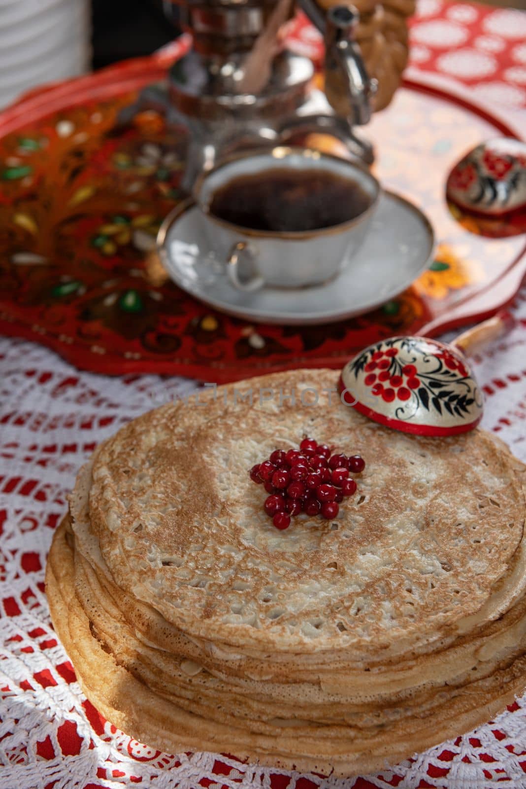 Russian pancake blini with berries and sour cream on the table. Shrovetide Maslenitsa festival concept. Top view. Flat lay