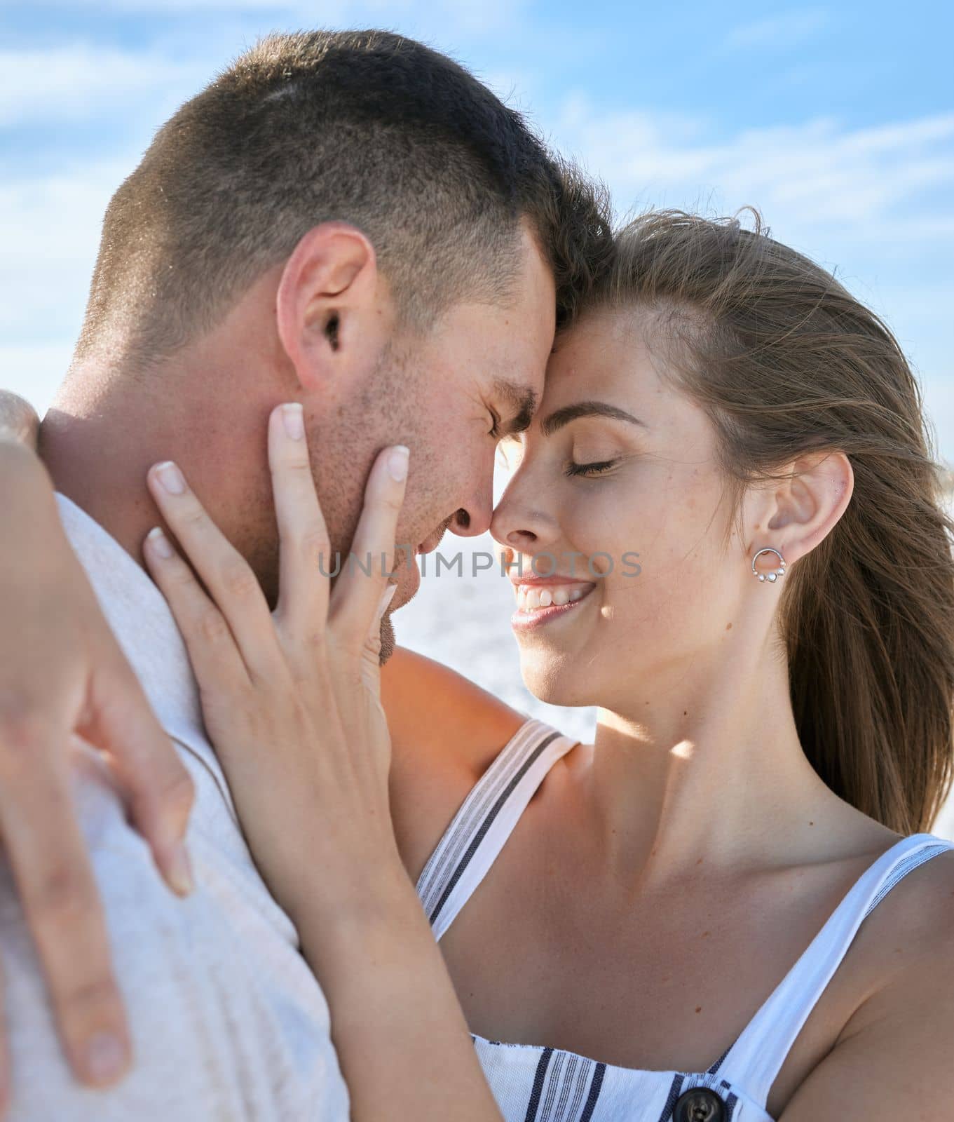 Couple, hug and forehead with smile for love, care or relationship bonding together in the outdoors. Happy man and woman touching heads and hugging for loving romance or embrace in satisfaction by YuriArcurs