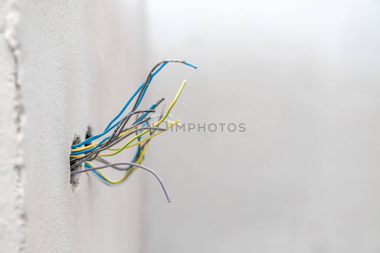 holes and wires in the wall for sockets and switches. High quality photo