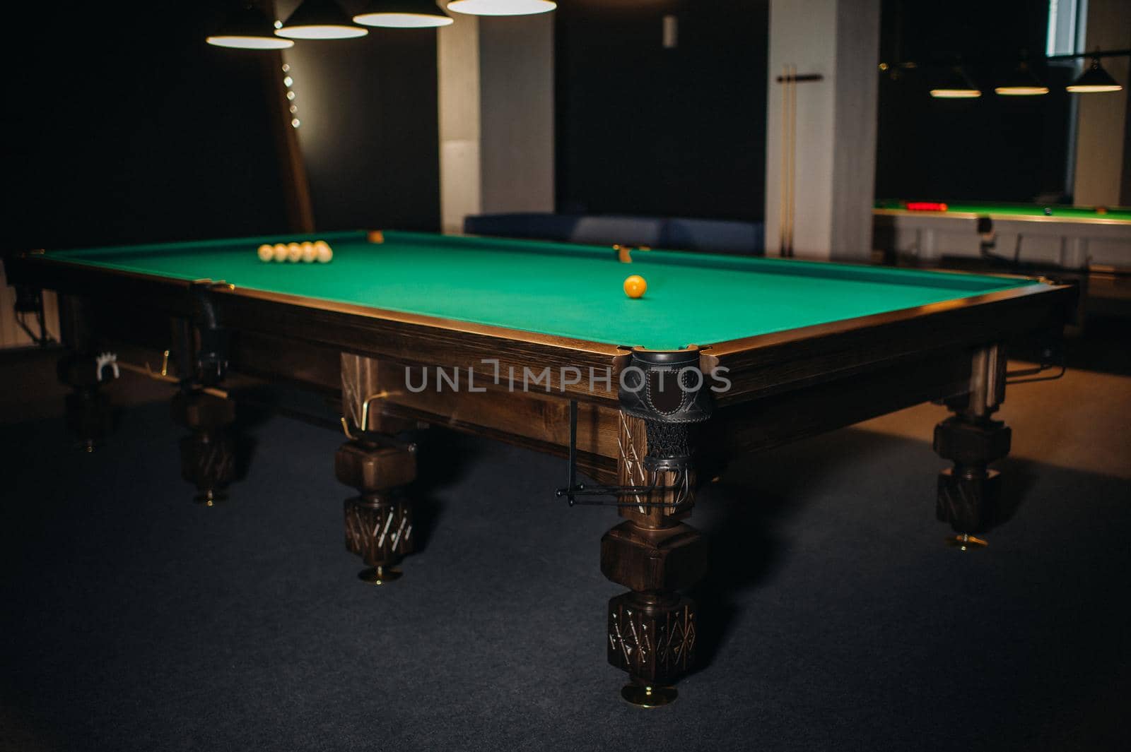 Billiard table with green surface and balls in the billiard club