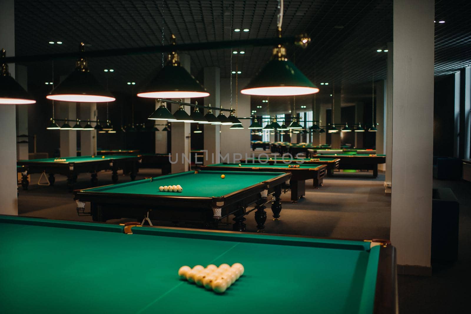 Billiard table with green surface and balls in the billiard club