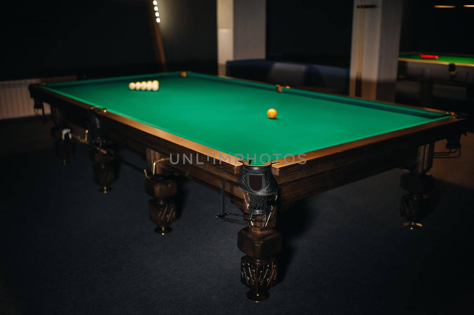Billiard table with green surface and balls in the billiard club