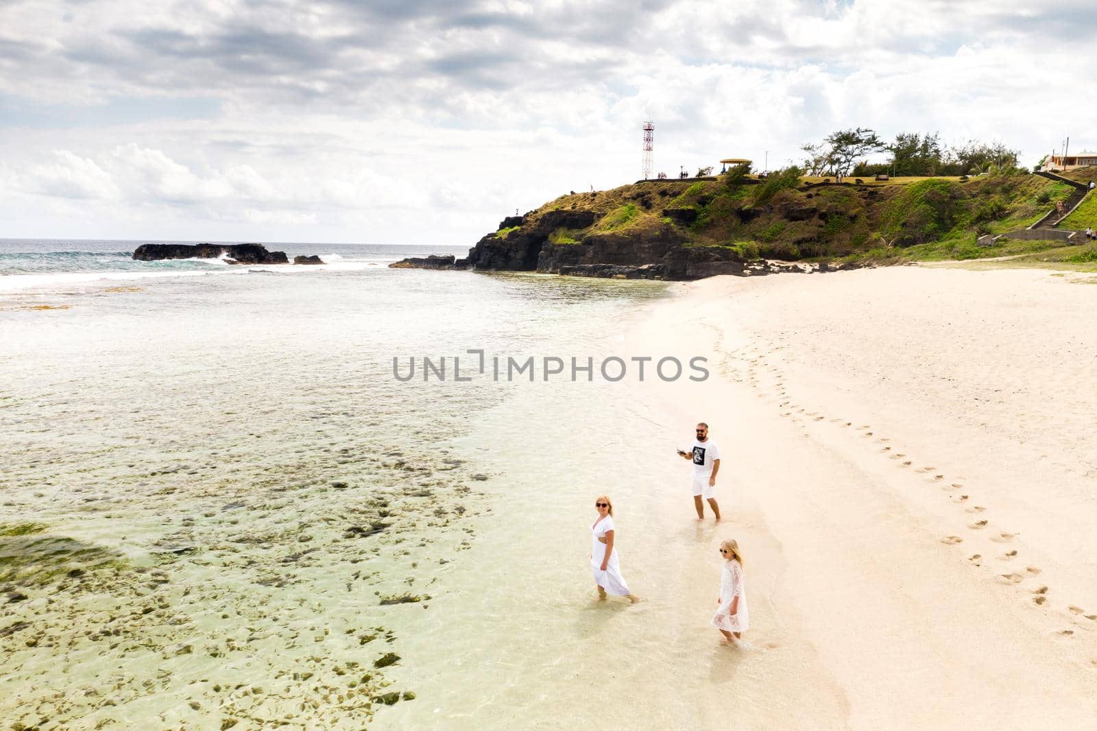 A family walks on Gris Gris beach in southern Mauritius in the Indian Ocean.