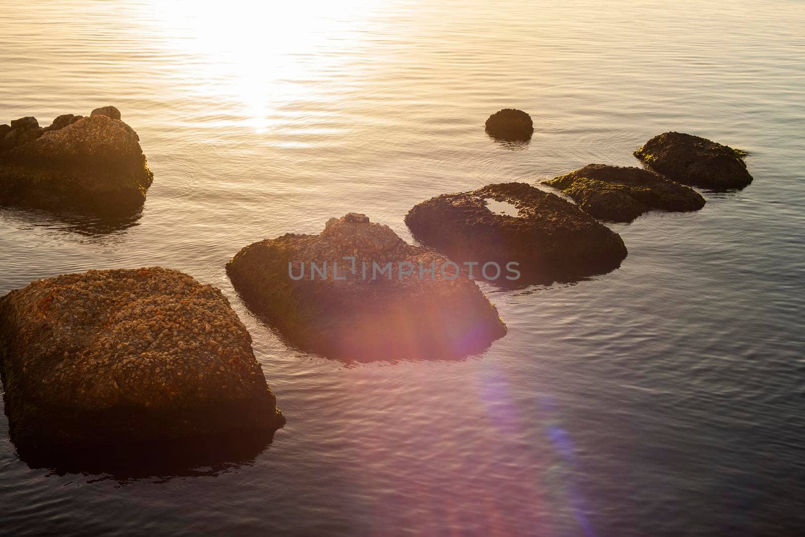 Rock on the sea at sunset in Ortigia, Syracuse