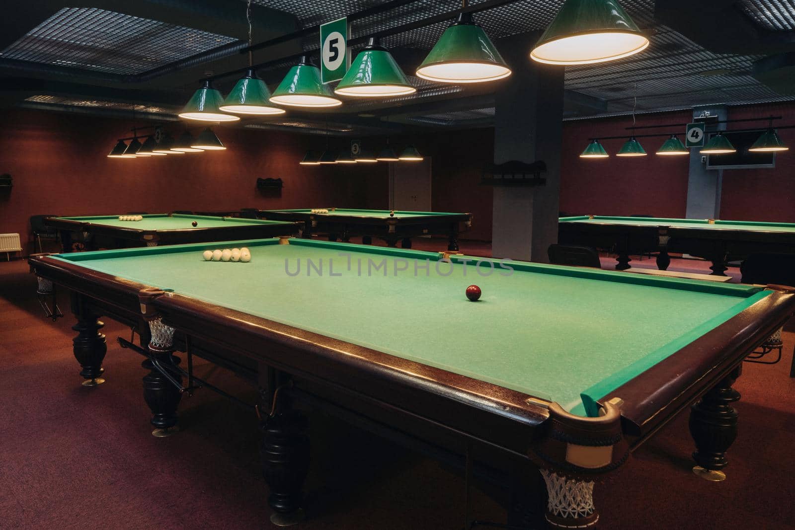 Billiard table with green surface and balls in the billiard club.Pool Game.