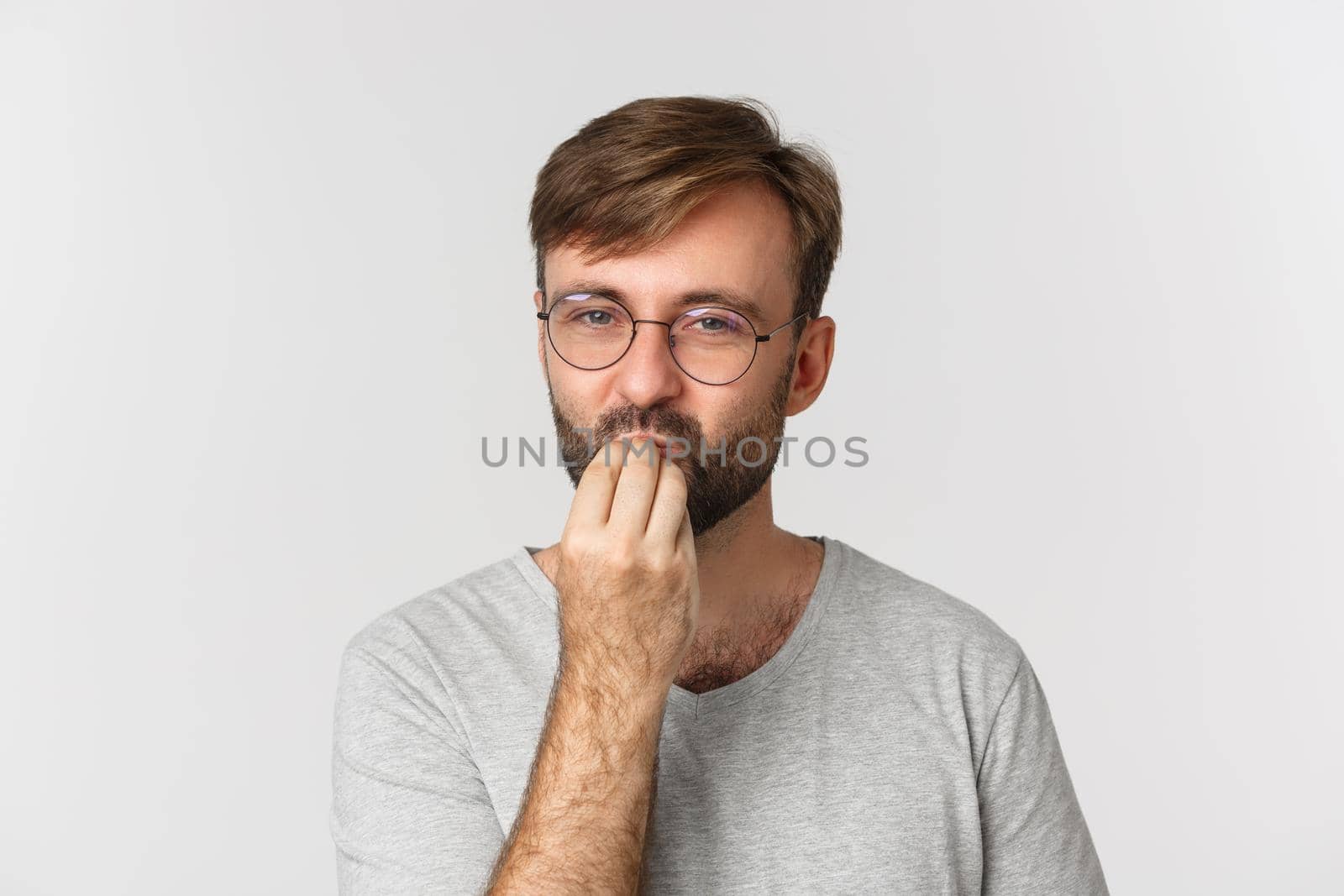 Close-up of handsome man in glasses giving a compliment, making chefs kiss sign, praising delicious food, standing over white background by Benzoix