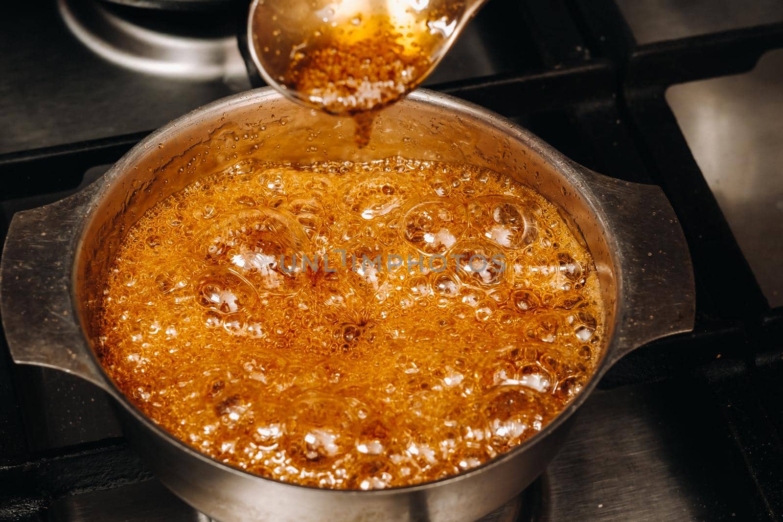 Preparation of sugar candies at home.A taste of our childhood.Rooster lollipops.Boiling Sugar caramel.