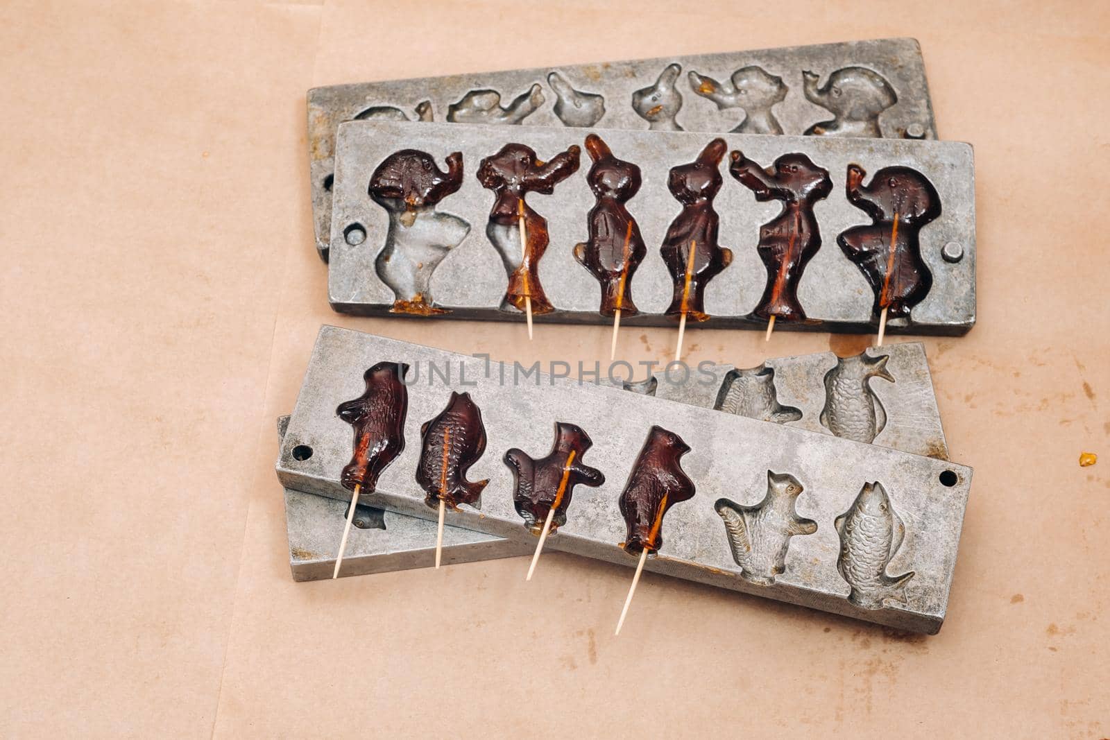 Making sugar lollipops at home.A taste of our childhood.Cockerel lollipops on a stick.Sugar caramel.