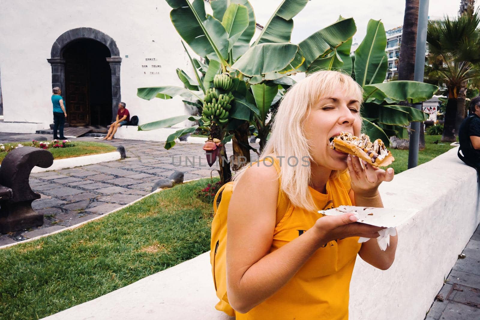 a female traveler eats hot ice cream on the island of Tenerife.Spain