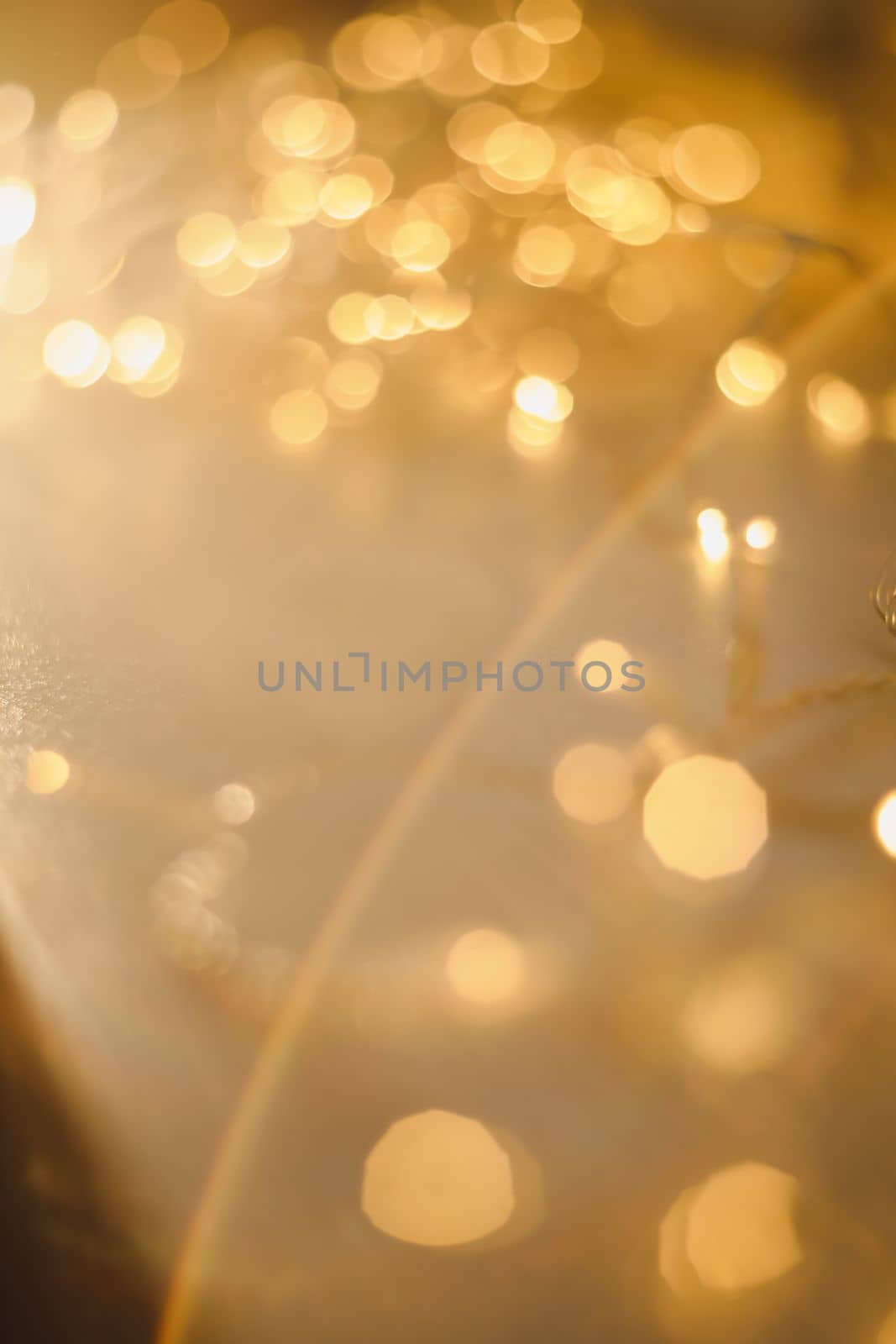 abstract shiny gold background. blured bokeh glowing golden background for design with copyspace. Shiny illumination lights by paralisart
