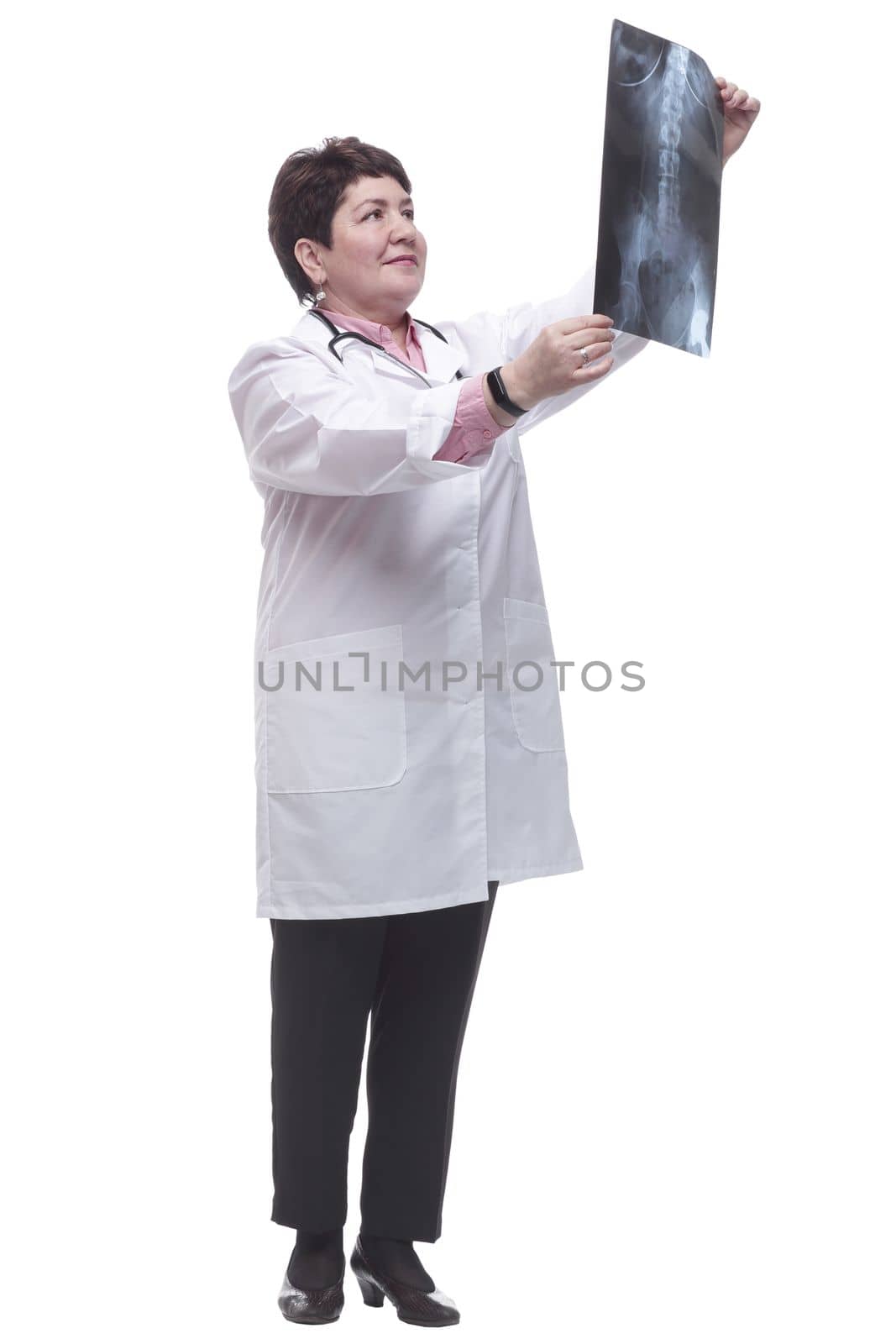 in full growth. a smiling female doctor examining an x -ray of a patient . isolated on a white background