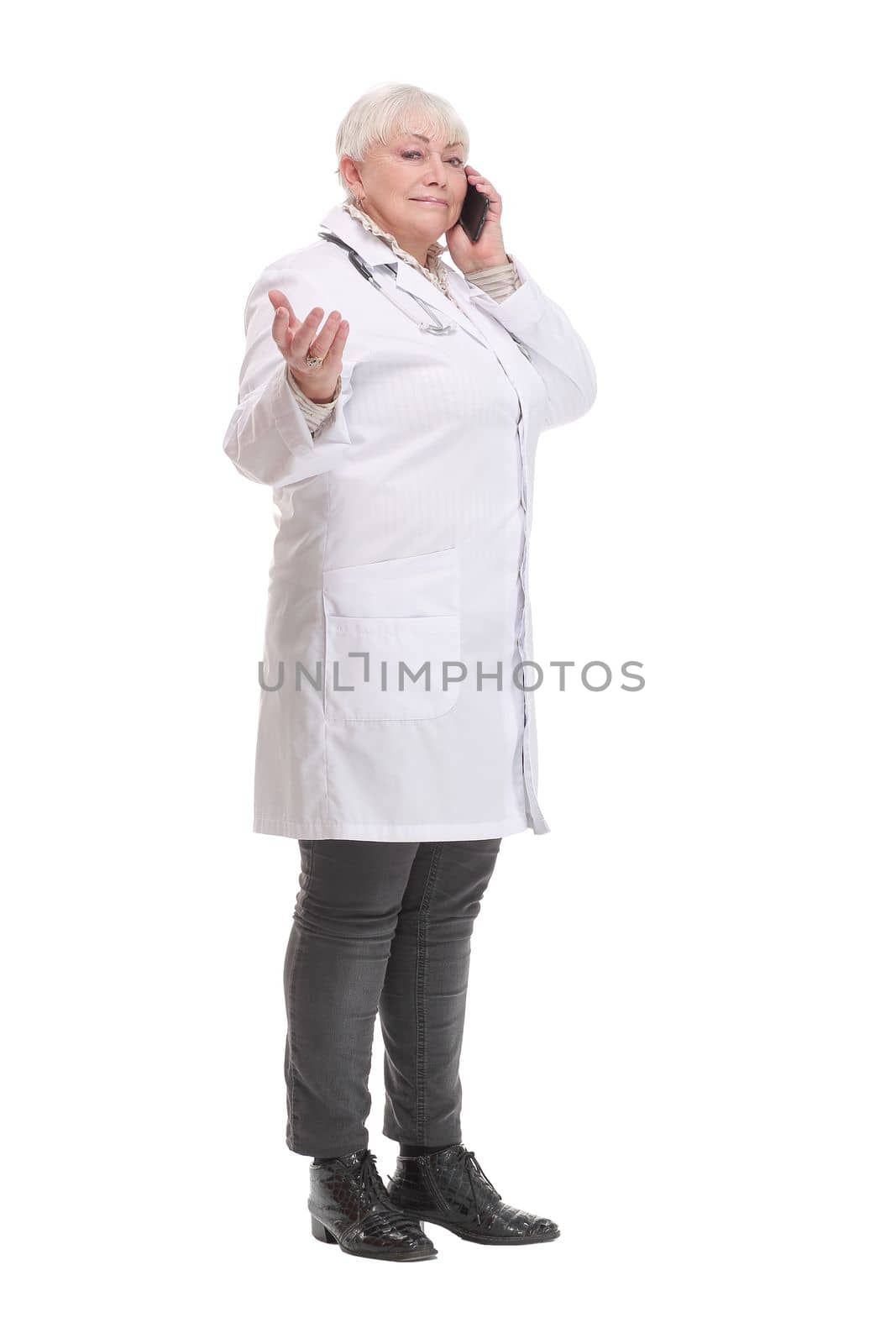 Portrait of middle aged female doctor talking with somebody on her mobile phone. Concept of healthcare worker.