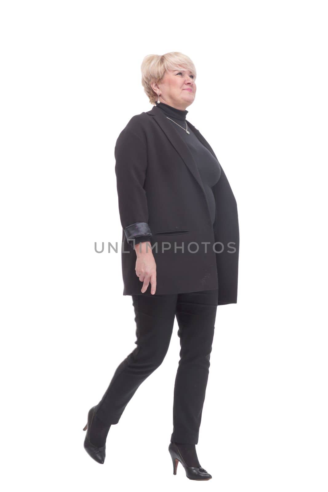 in full growth.confident business woman striding forward. isolated on a white background.