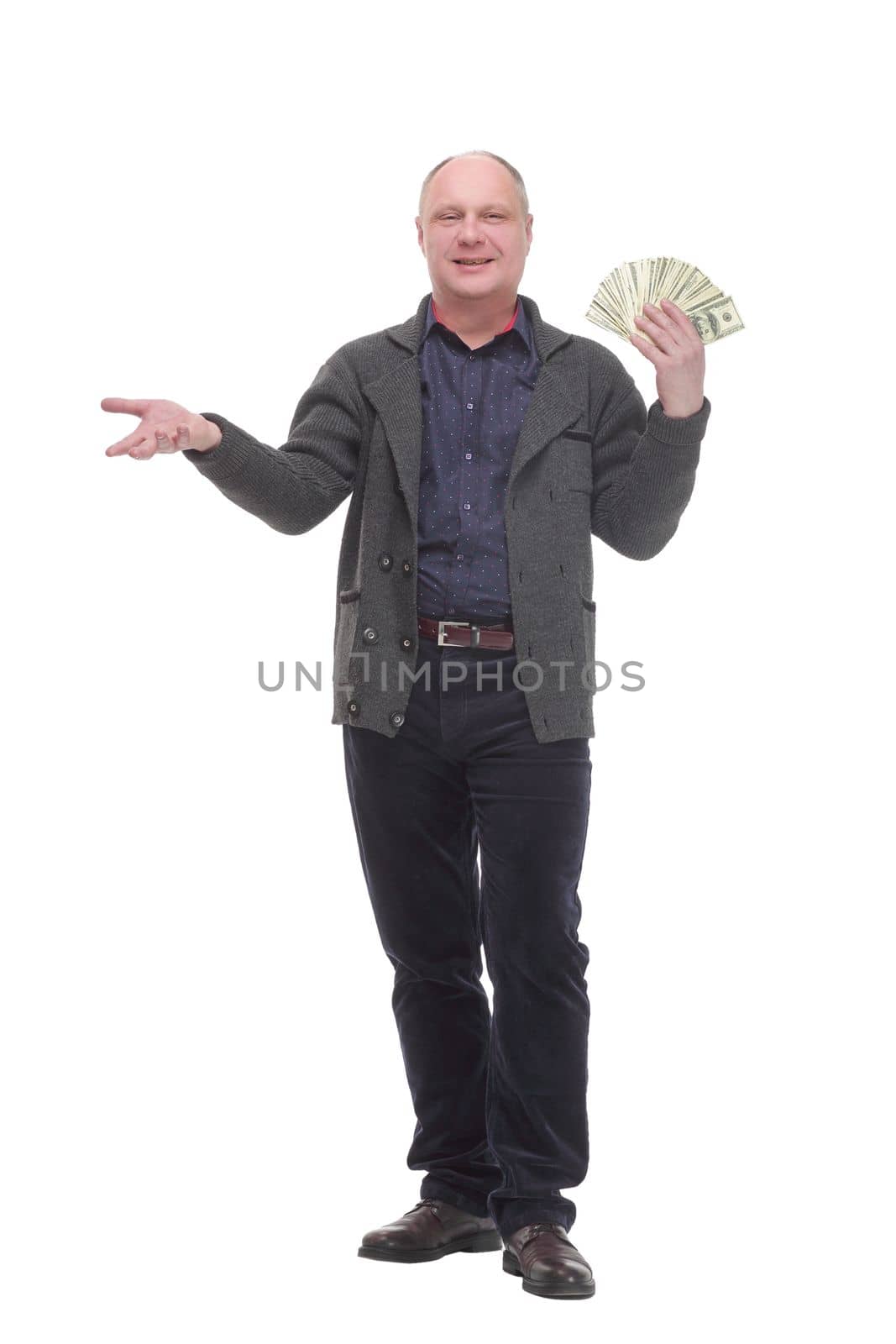 in full growth. happy casual man with dollar bills .isolated on a white background.