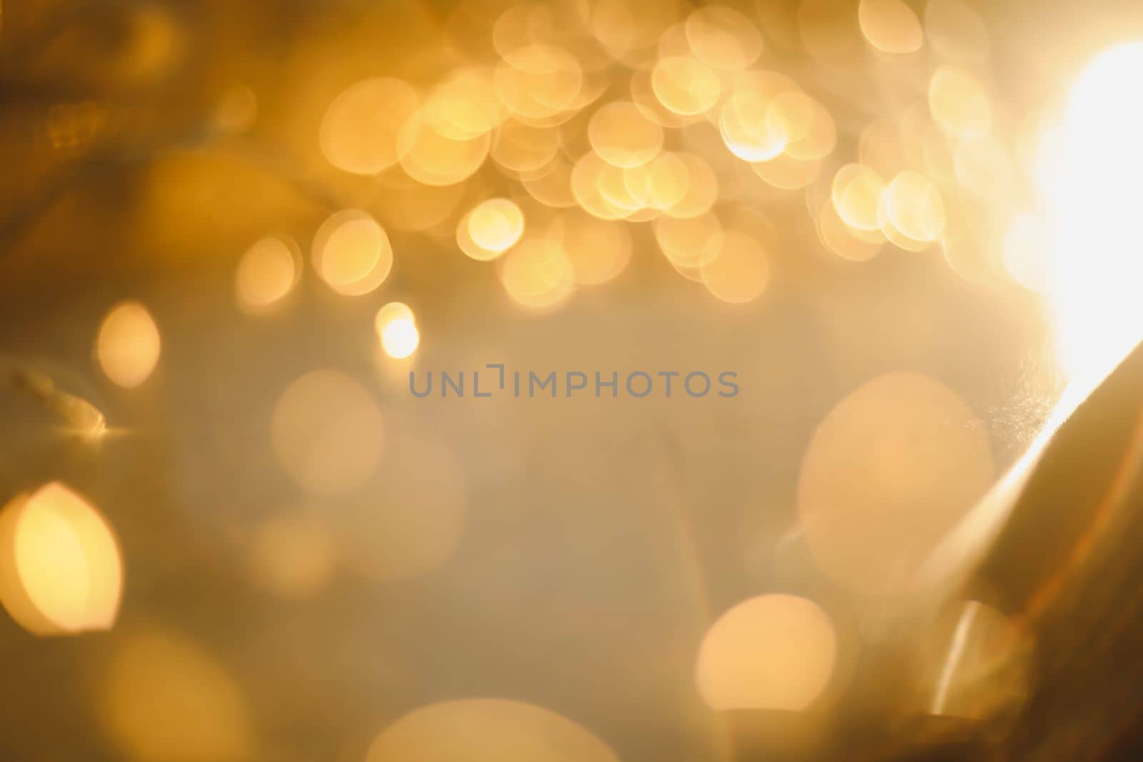 abstract shiny gold background. blured bokeh glowing golden background for design with copyspace