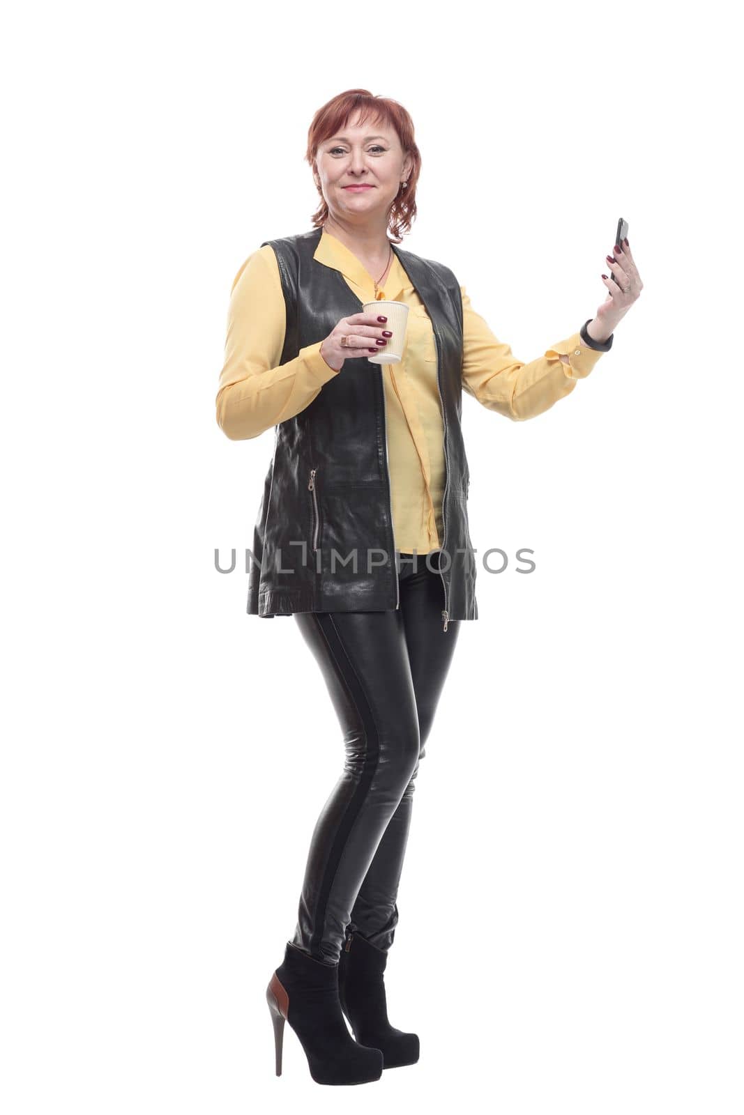 mature woman with smartphone and coffee to take away . isolated on a white background.