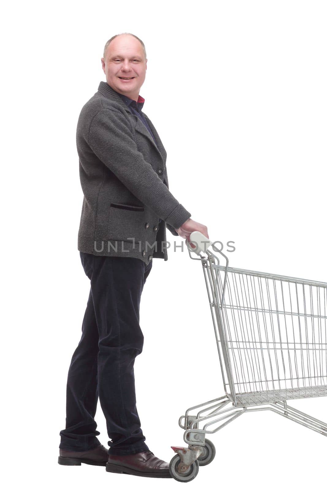 smiling casual man with shopping cart .isolated on a white background. by asdf