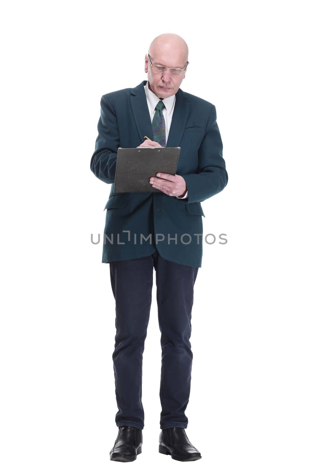 in full growth. serious business man with glasses taking notes on the clipboard. isolated on a white background.