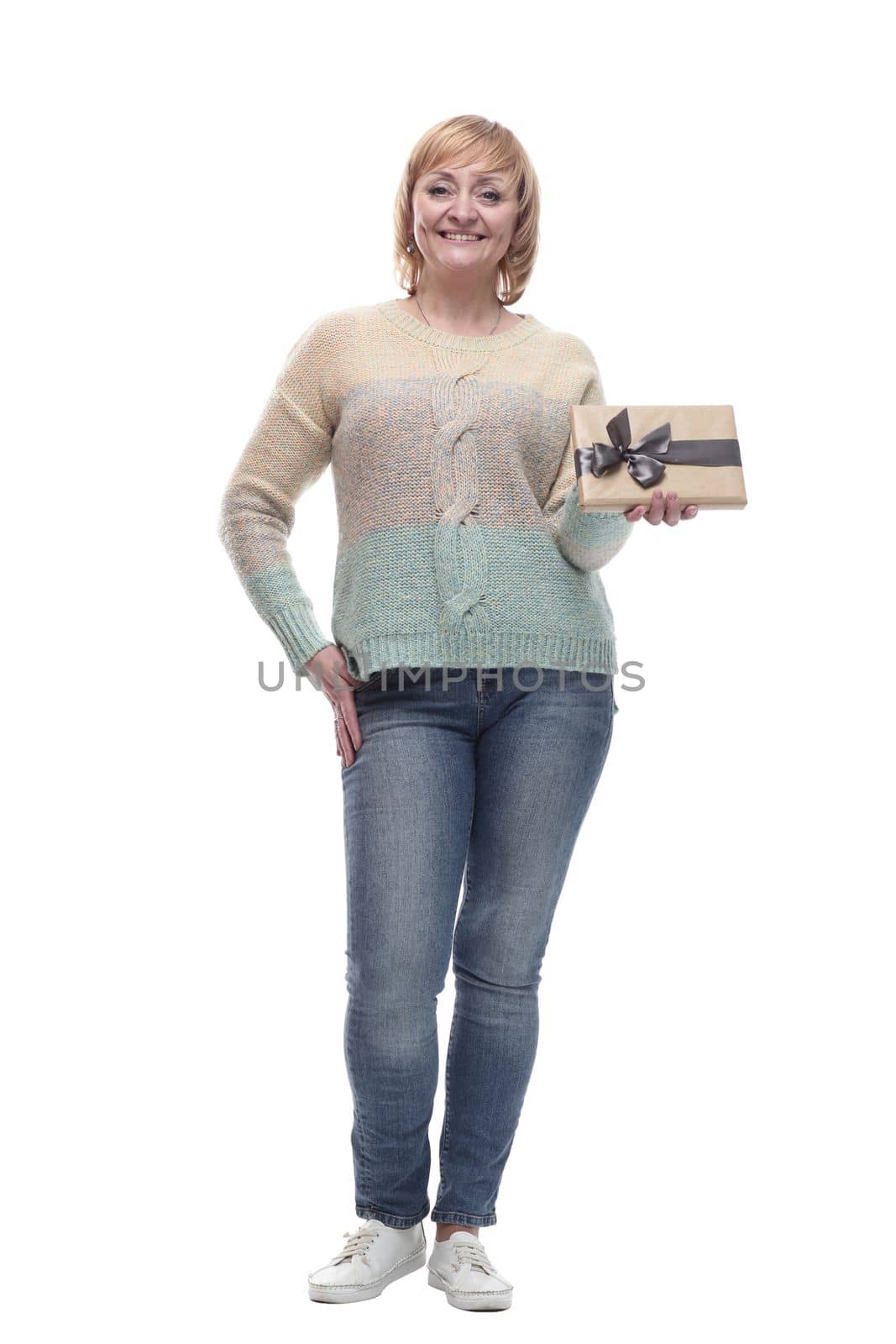 in full growth. attractive casual woman with a gift box. isolated on a white background.