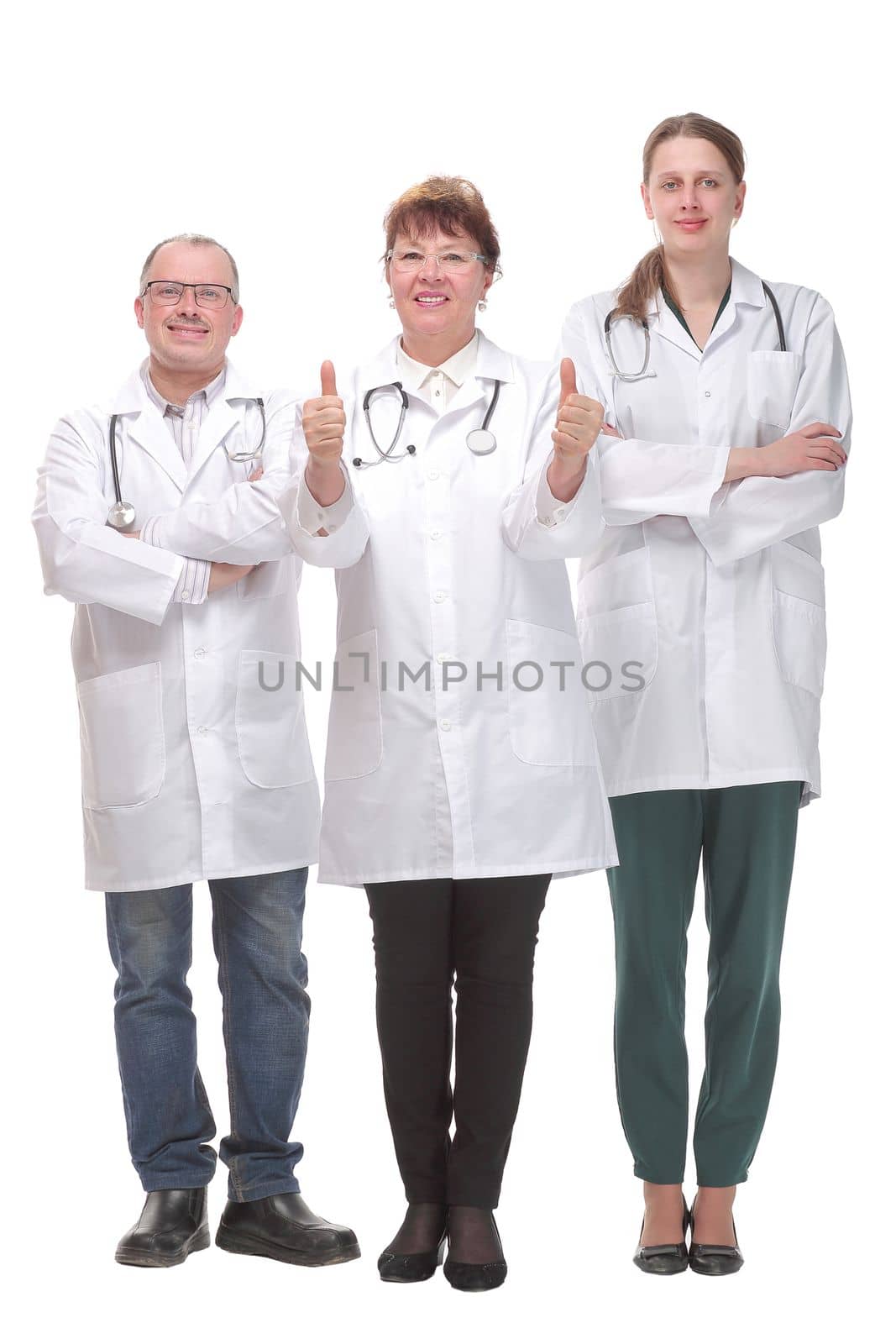 Team of doctors standing arms crossed and smiling at camera. Concept of medical help and confidence