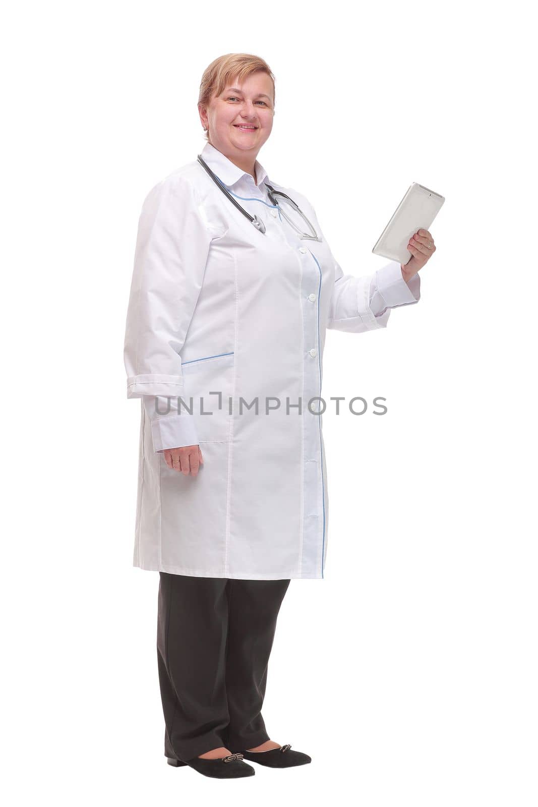 Side view of professional doctor or nurse woman in labcoat uniform with stethoscope on neck and check tablet smiles in studio white background