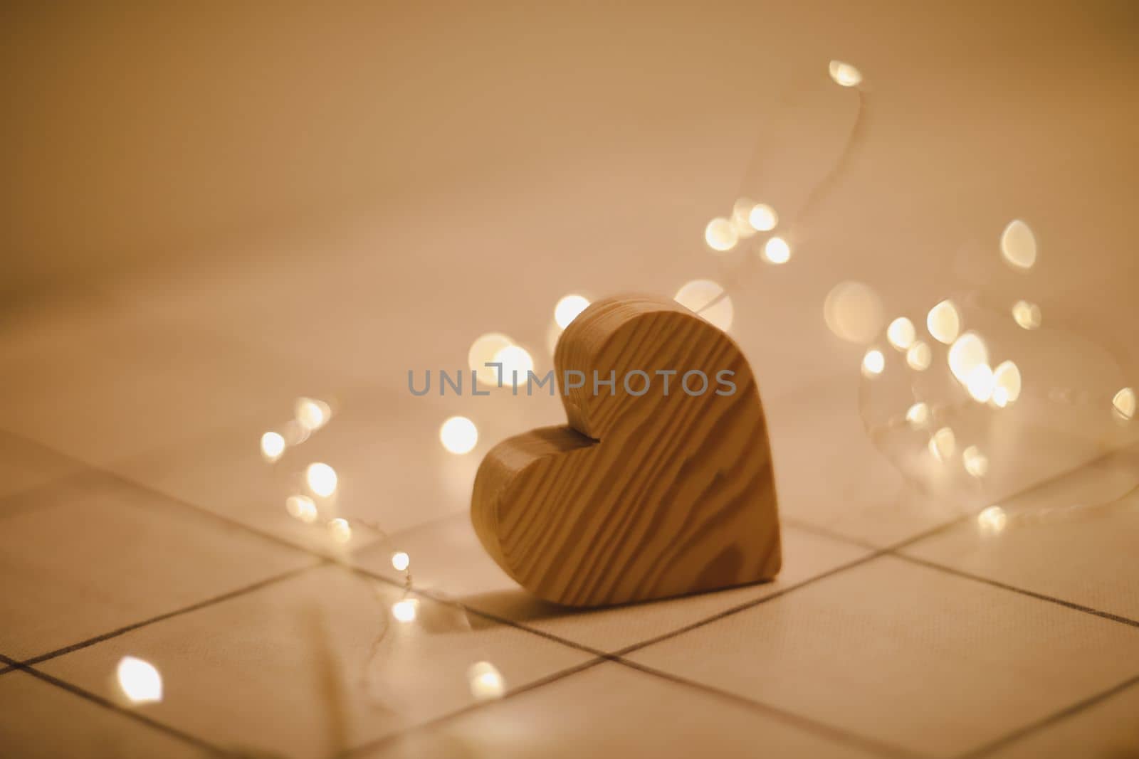 Valentines Day, Wedding concept - Wooden Heart by defocused blurred lights.