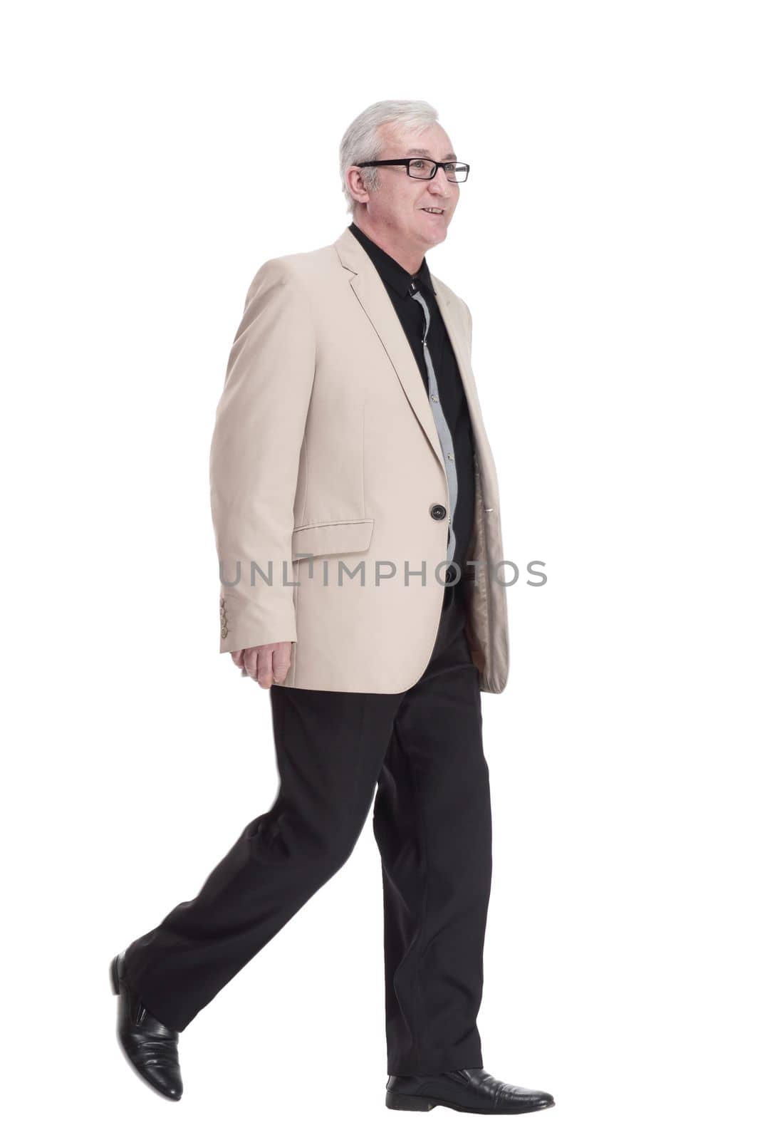 intelligent mature man in a white jacket walking forward . by asdf