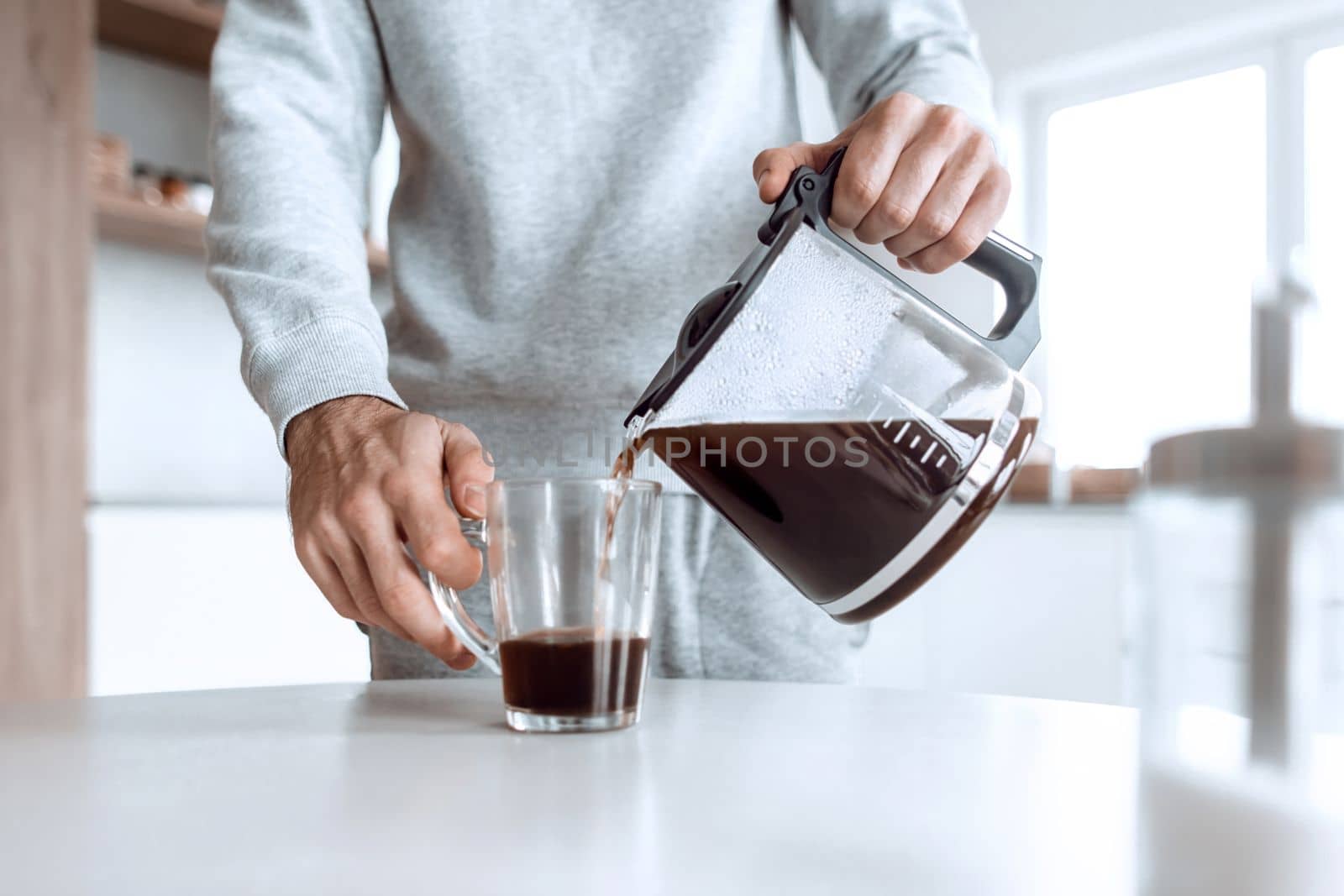 close up. a man pours himself a cup of coffee