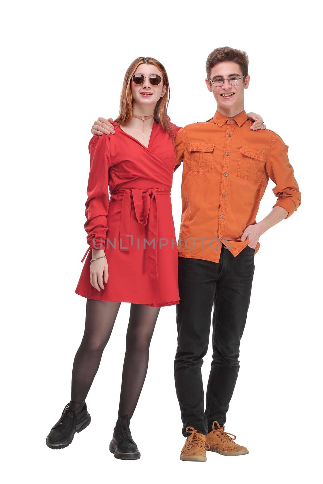 Portrait of happy couple in bright clothes embracing and looking at camera by asdf