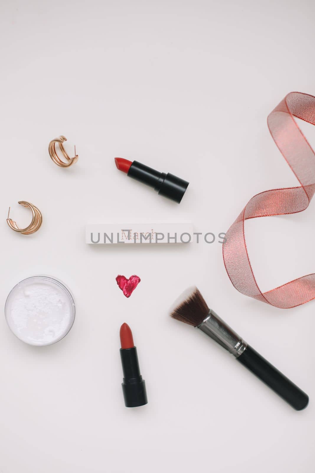 Concept Women's Day, Valentines Day, March 8. Lipsticks, cosmetic makeup products and accessories flatlay top view. by paralisart