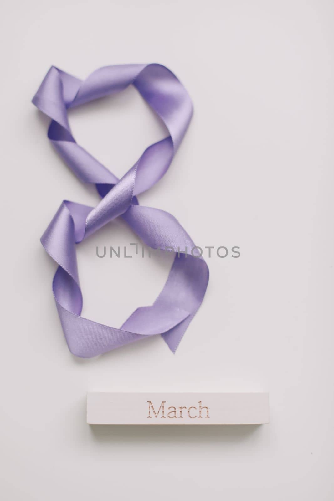 Eight made of violet ribbon. 8 March greeting card template. International Women's day background, banner, poster or brochure.