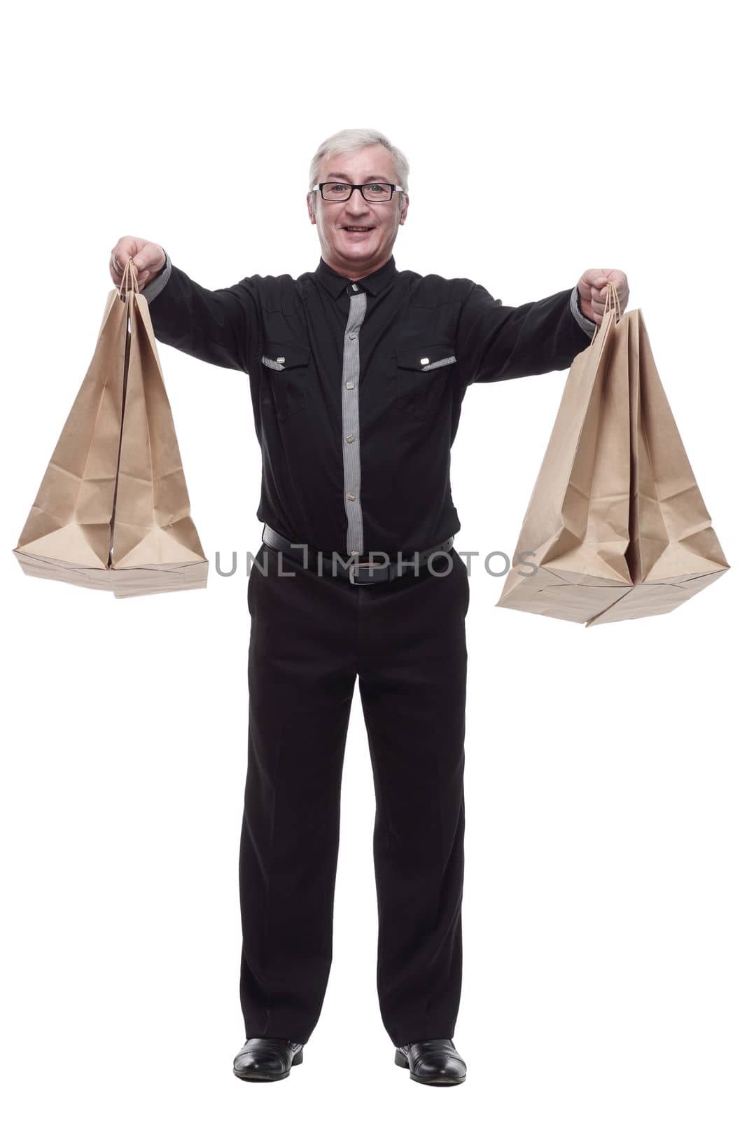 in full growth. happy casual man with shopping bags. isolated on a white background.