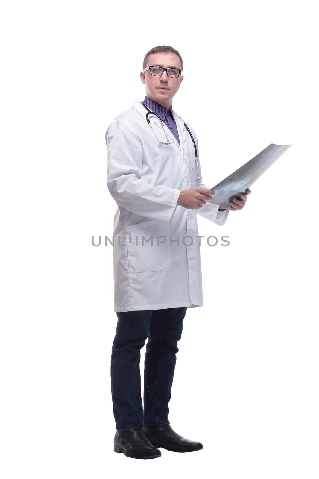 Attractive doctor examining an x-ray and looking at the camera seriously