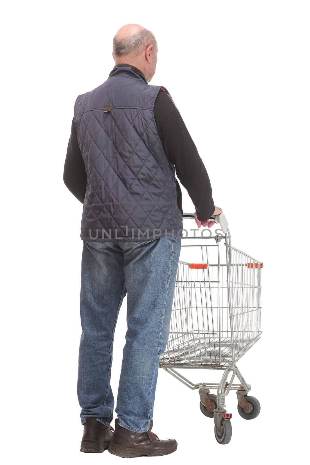 A full length portrait of a man pushing an empty shopping cart and sign ok isolated on white background