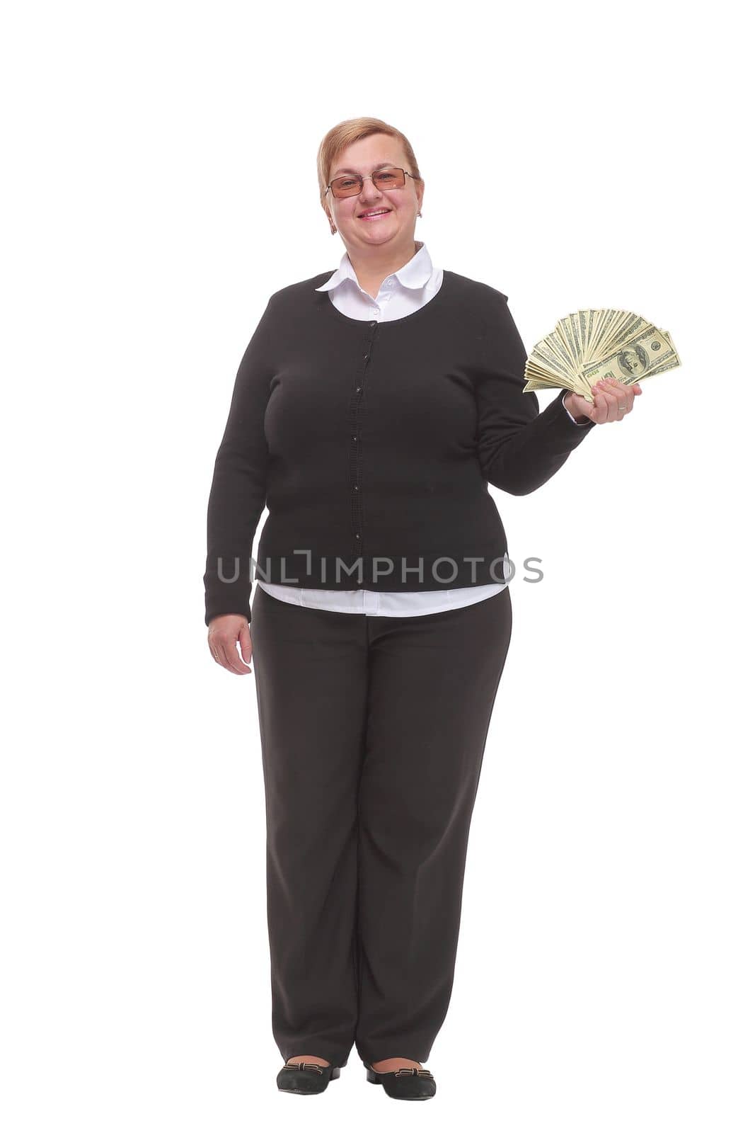 Front view of senior brunette businesswoman in black suit holding money isolated on white