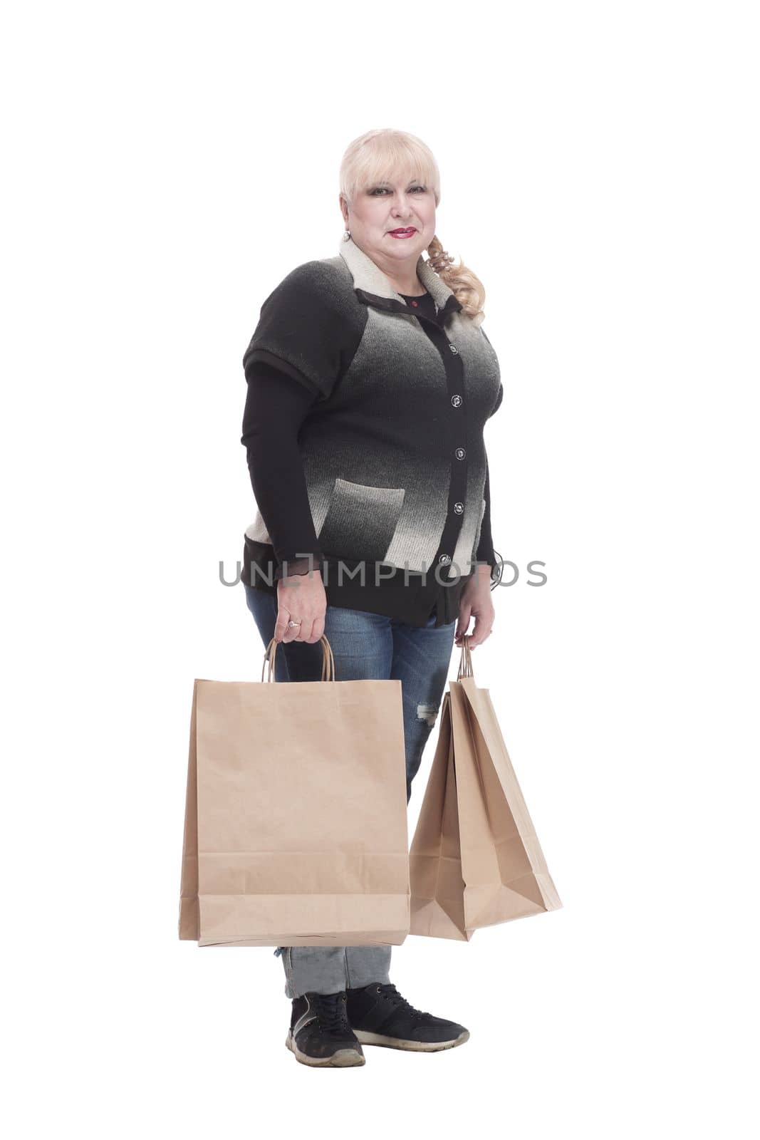 full-length. casual woman in jeans with shopping bags. isolated on a white background.