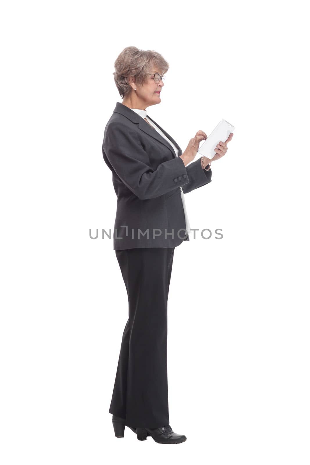 Smiling business woman in black suit with tablet computer. Isolated over white background