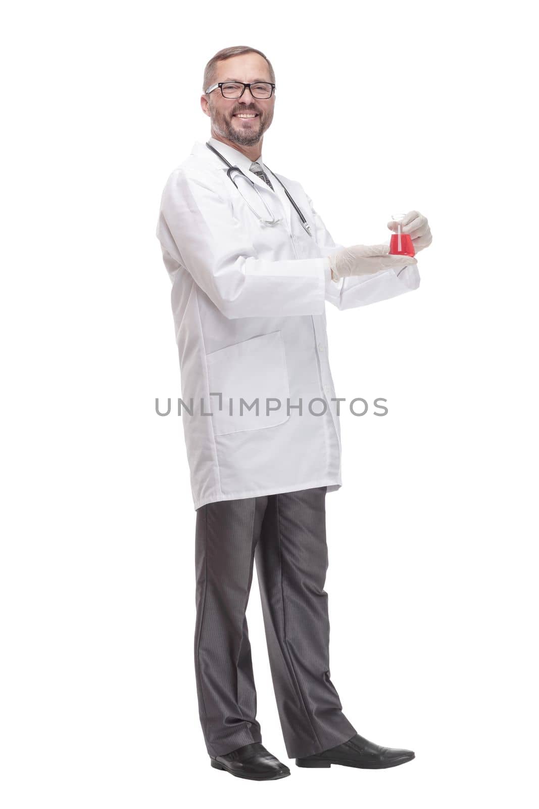 smiling doctor with a laboratory flask in his hands . isolated on a white background.