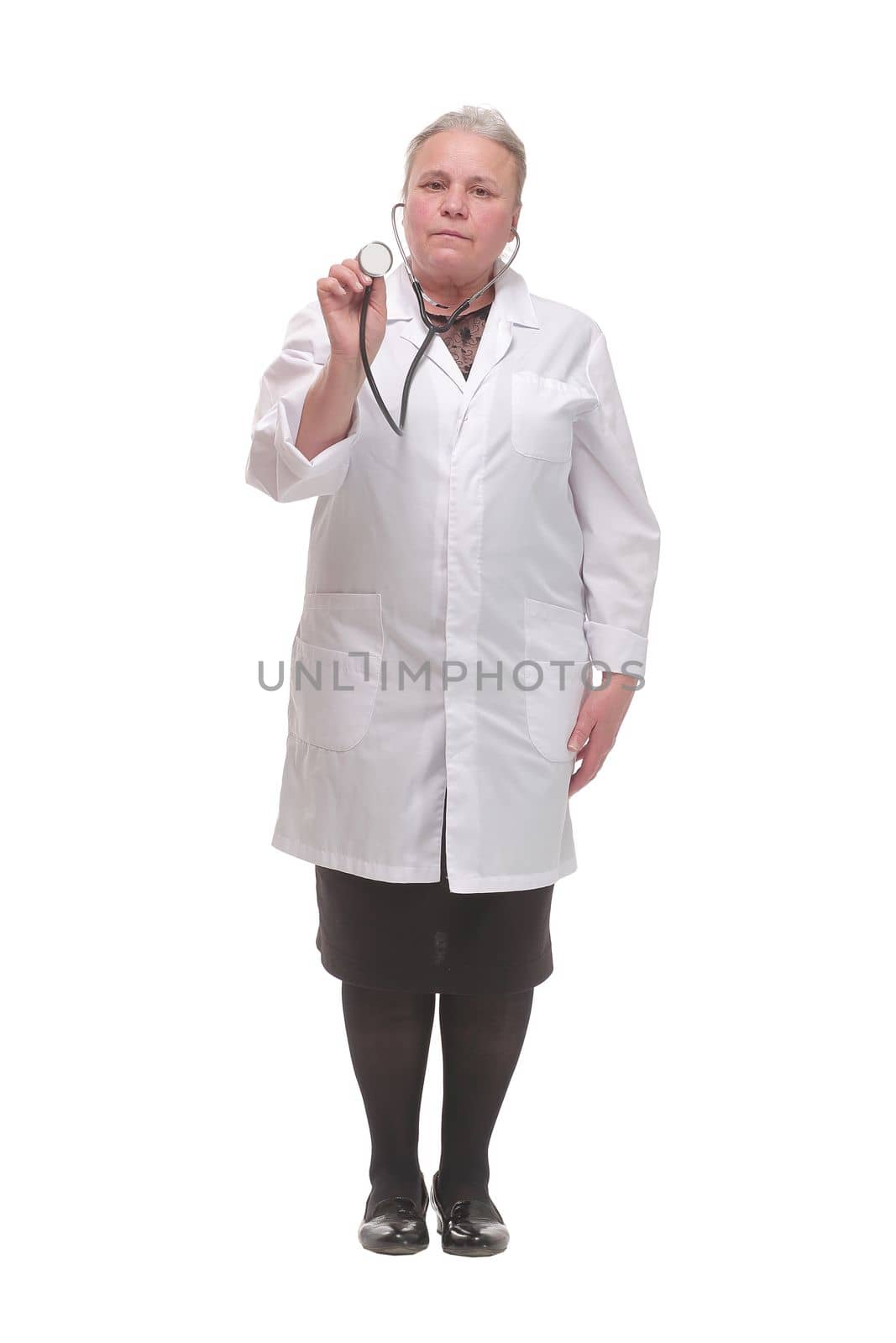 A female doctor with a stethoscope listening and looking at camera, isolated on white background