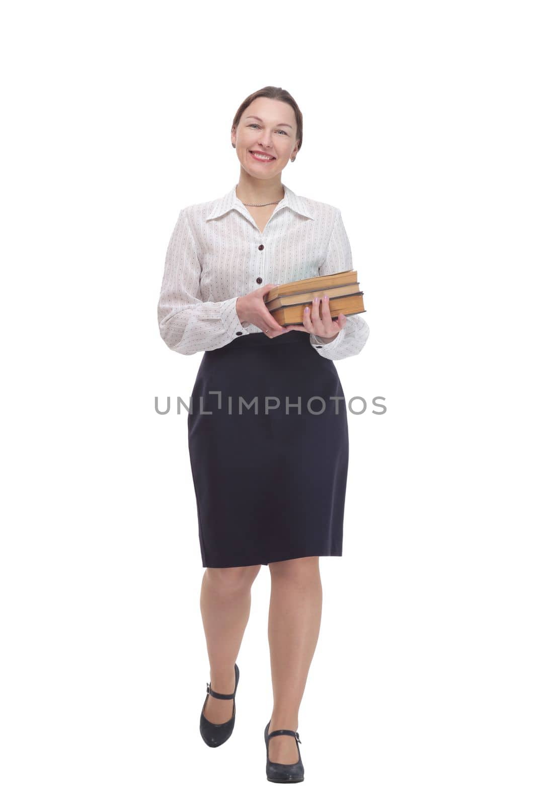 in full growth. businesswoman with a stack of books. isolated on a white background.