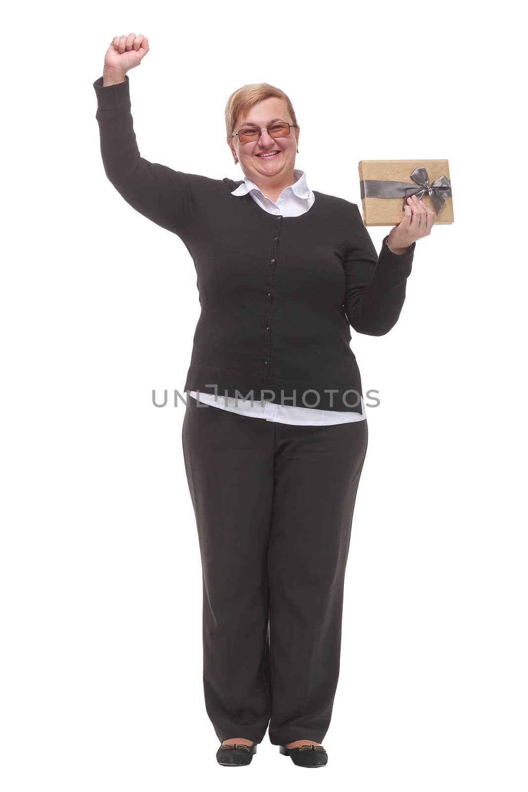 Nice happy woman pointing up with her finger while holding a present box. Concept of positive emotions.