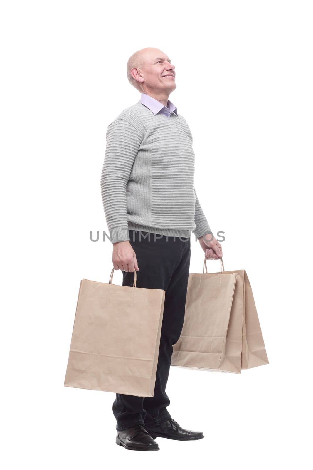 in full growth. happy man with shopping bags. isolated on a white background.