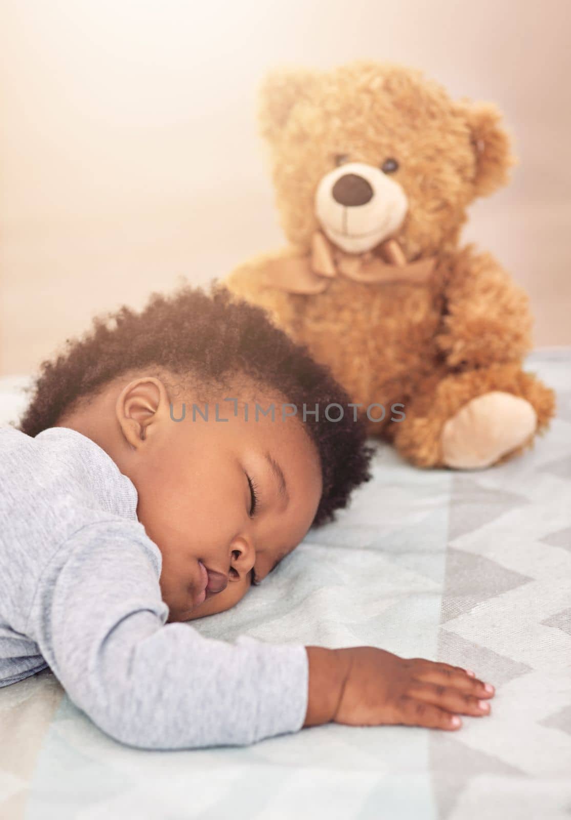 Is there anything more adorable than a sleeping baby. a little baby boy sleeping on a bed with a teddy bear. by YuriArcurs