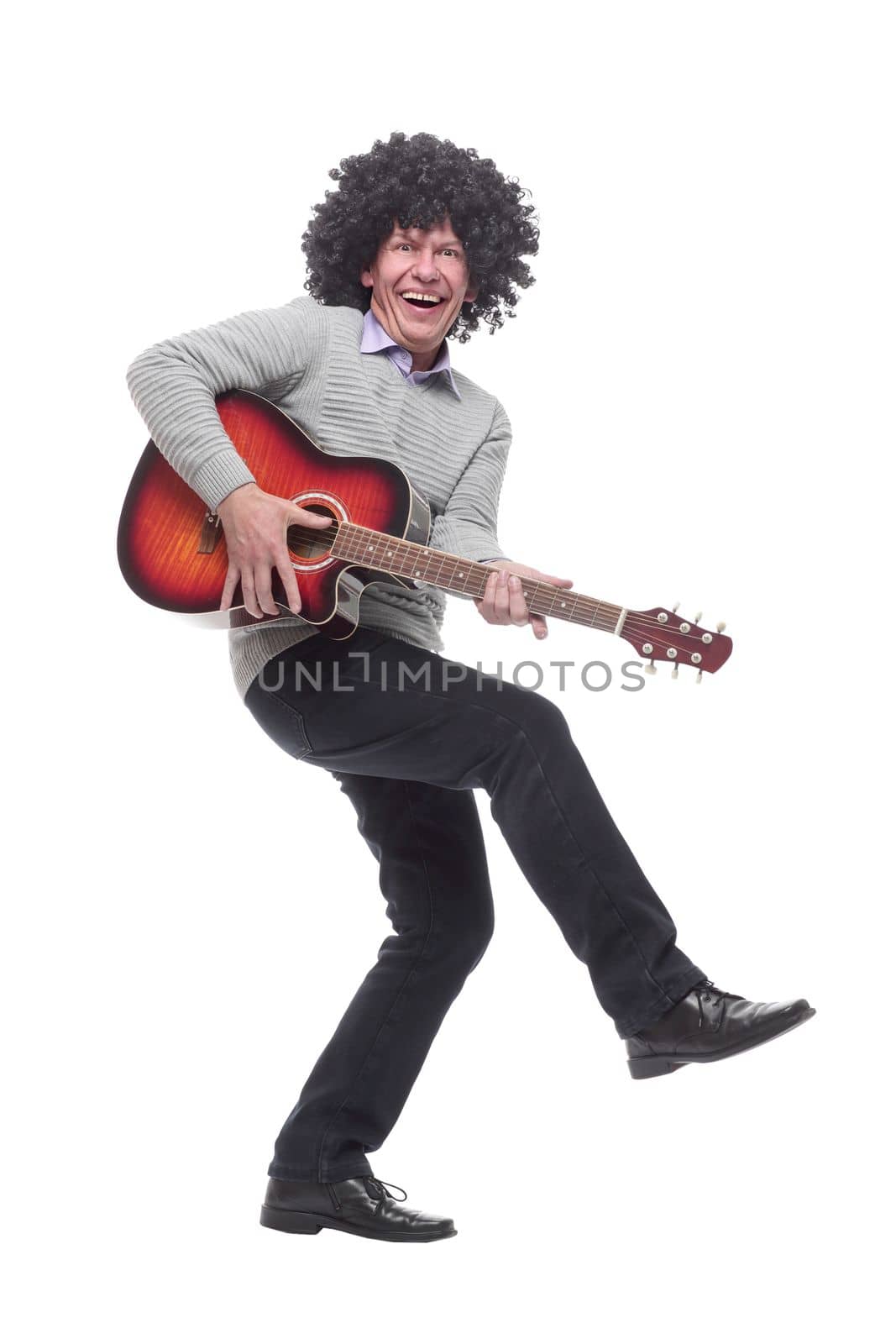 in full growth. cheerful man with a guitar. isolated on a white background.