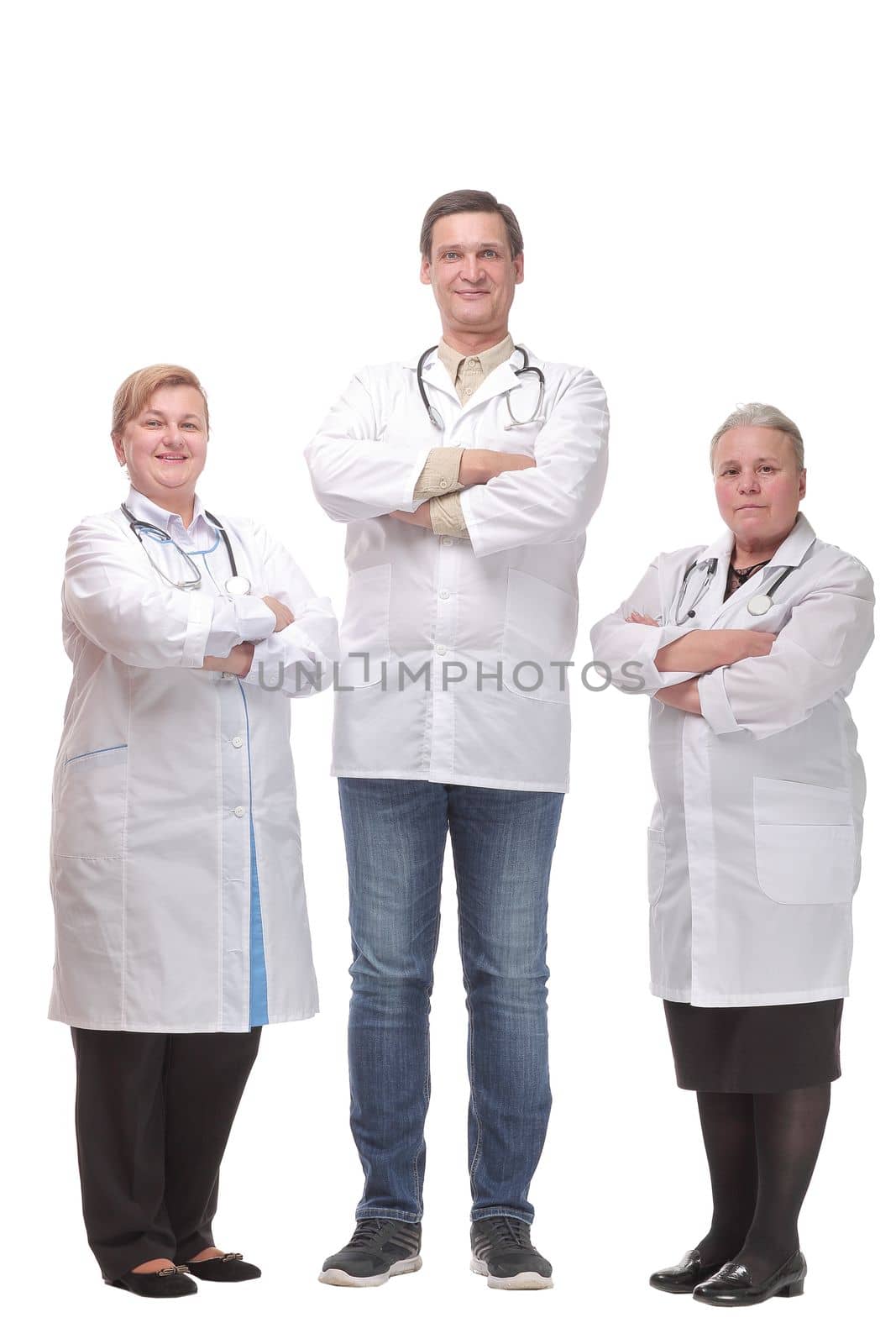 Portrait of confident happy group of doctors standing at white background and looking at camera